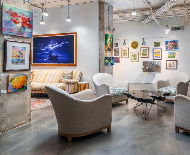 a room with couches and paintings on the wall