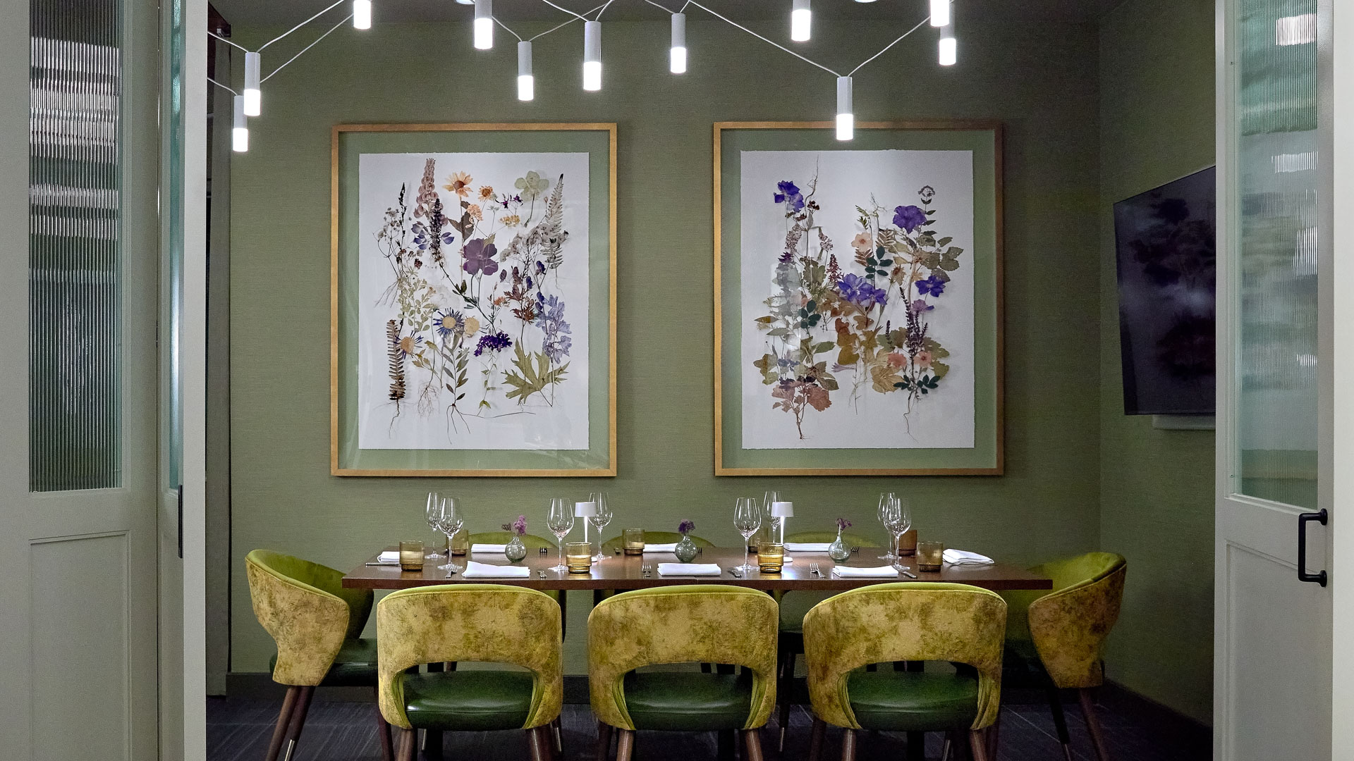 a table with chairs and art on the wall