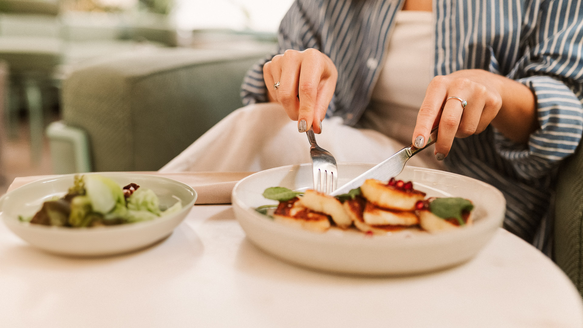 a person eating food with a fork and knife