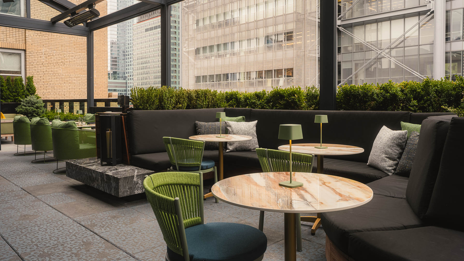 a table and chairs outside with a large window