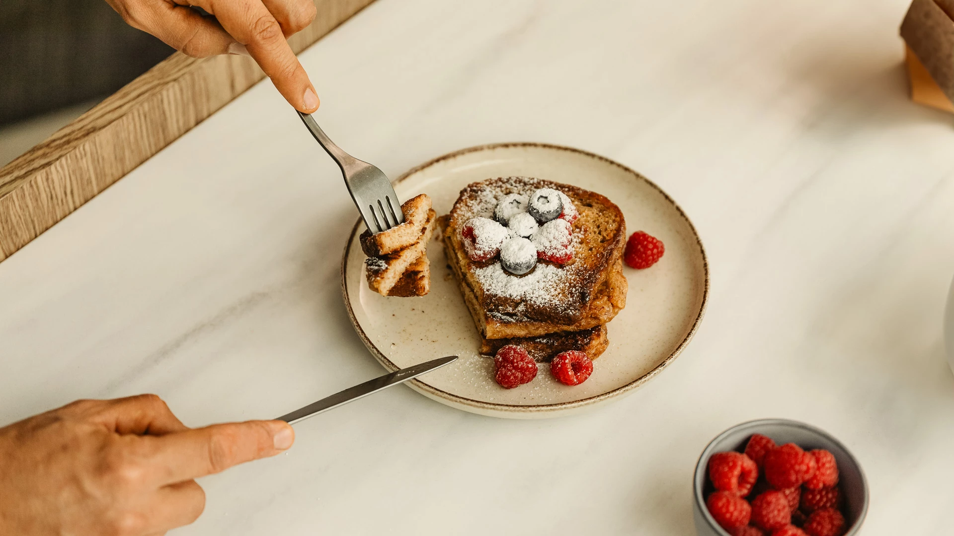 a person eating a piece of food with a fork