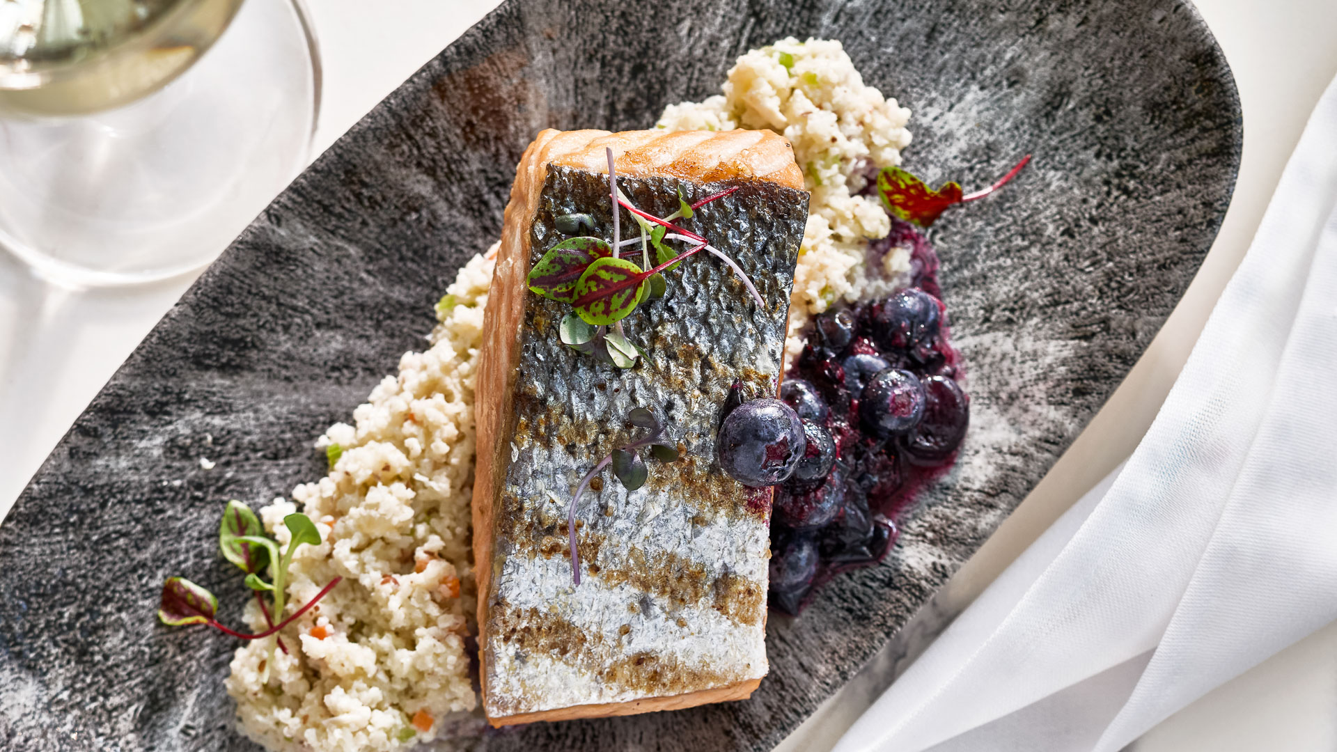 a plate of food with a piece of fish and rice