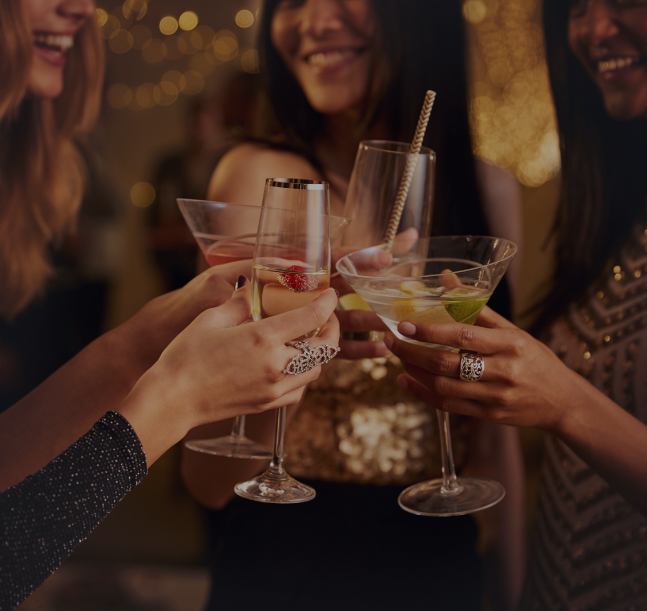a group of women holding drinks