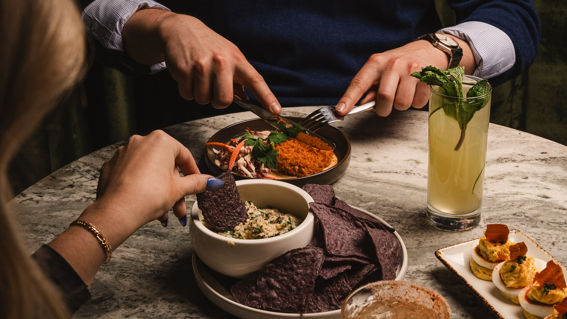 a person eating food with a fork and knife