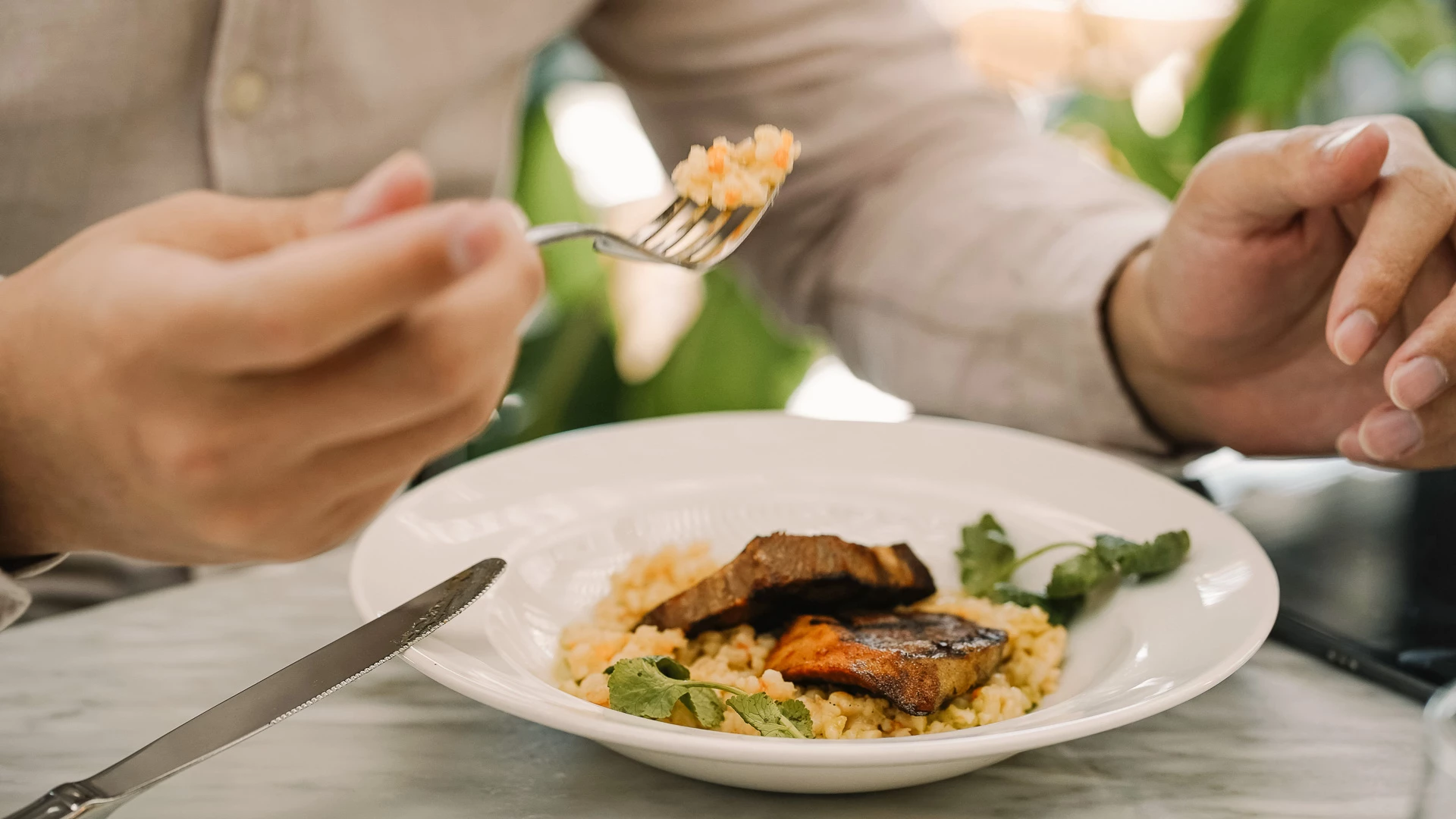 a person eating food on a plate