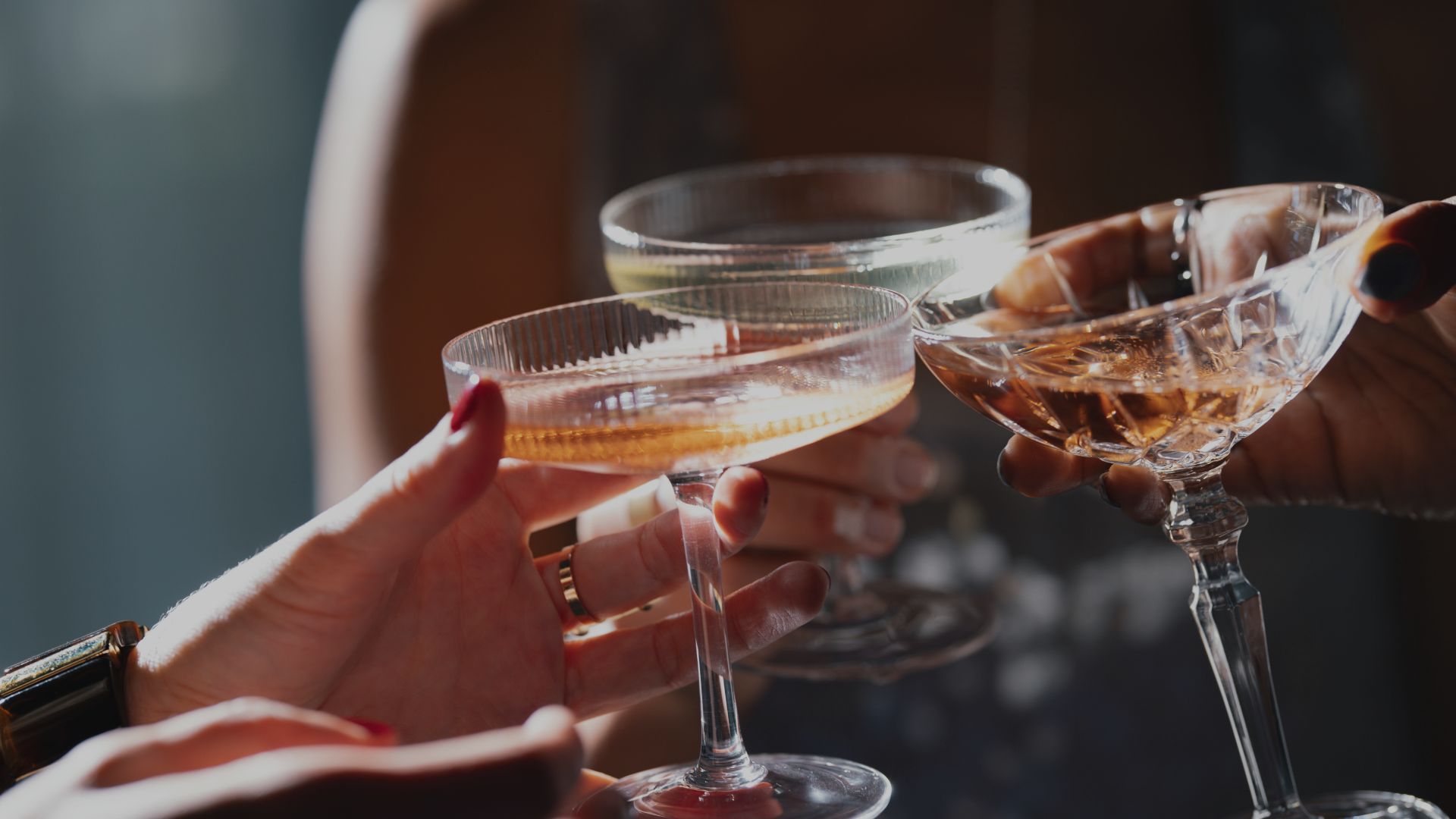 a group of people holding up a glass of wine