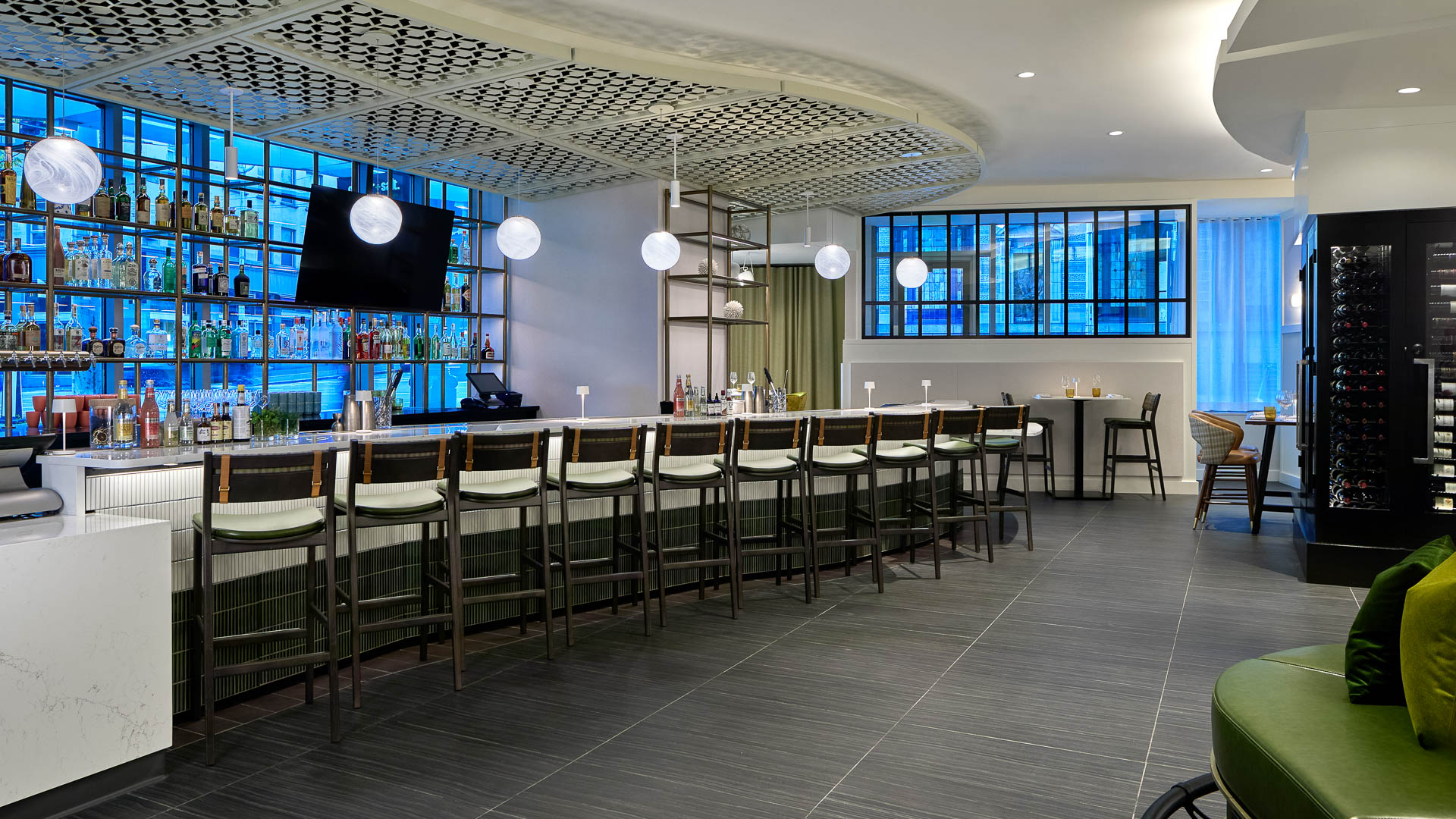 a room with a long bar and chairs
