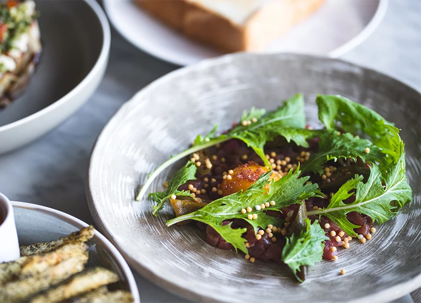 a plate of food with greens and bread