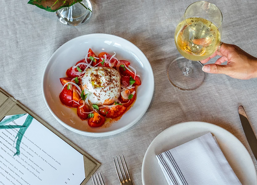 a plate of food and a glass of wine