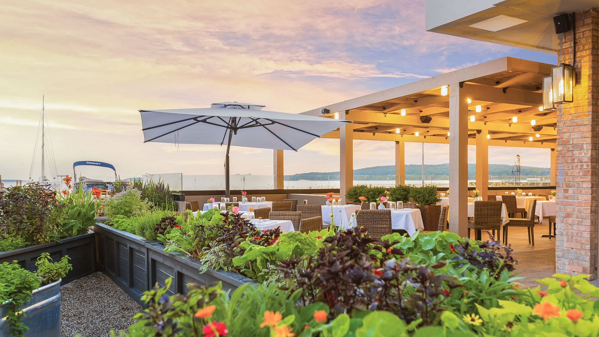 a patio with tables and chairs and umbrellas