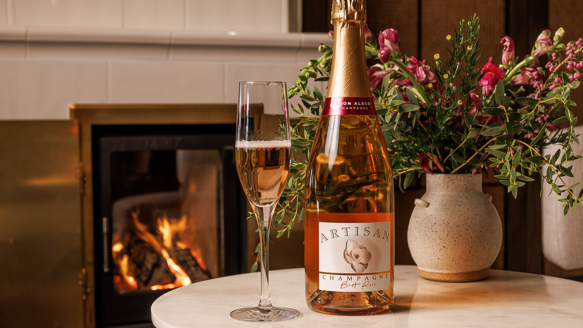 a bottle of champagne next to a glass of wine
