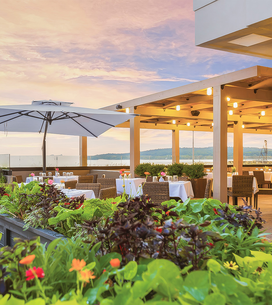 a patio with tables and chairs and umbrellas