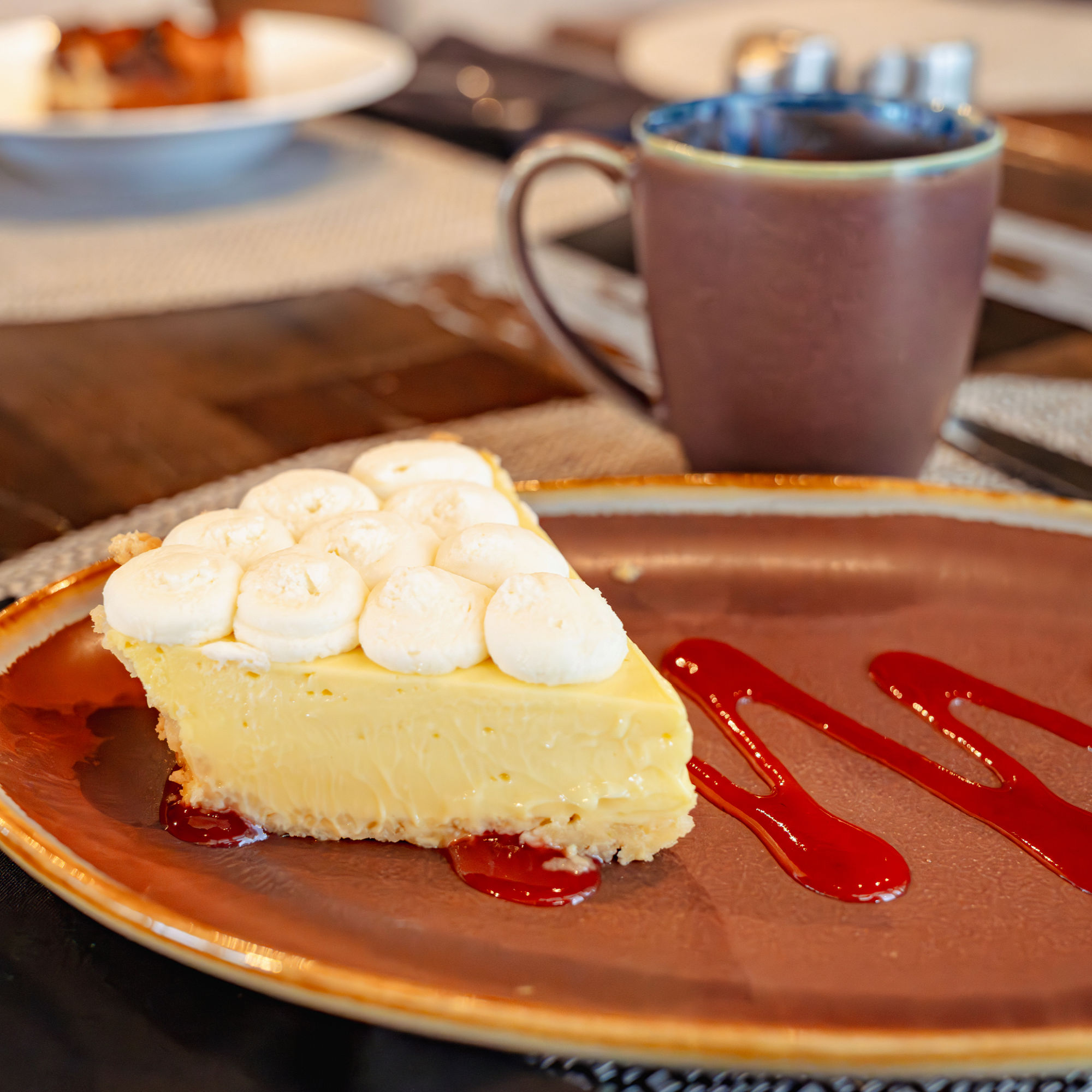 a slice of cheesecake with marshmallows and syrup on a plate