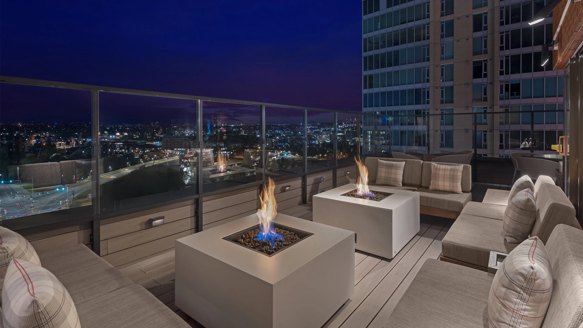 a fire pit on a deck with a city view