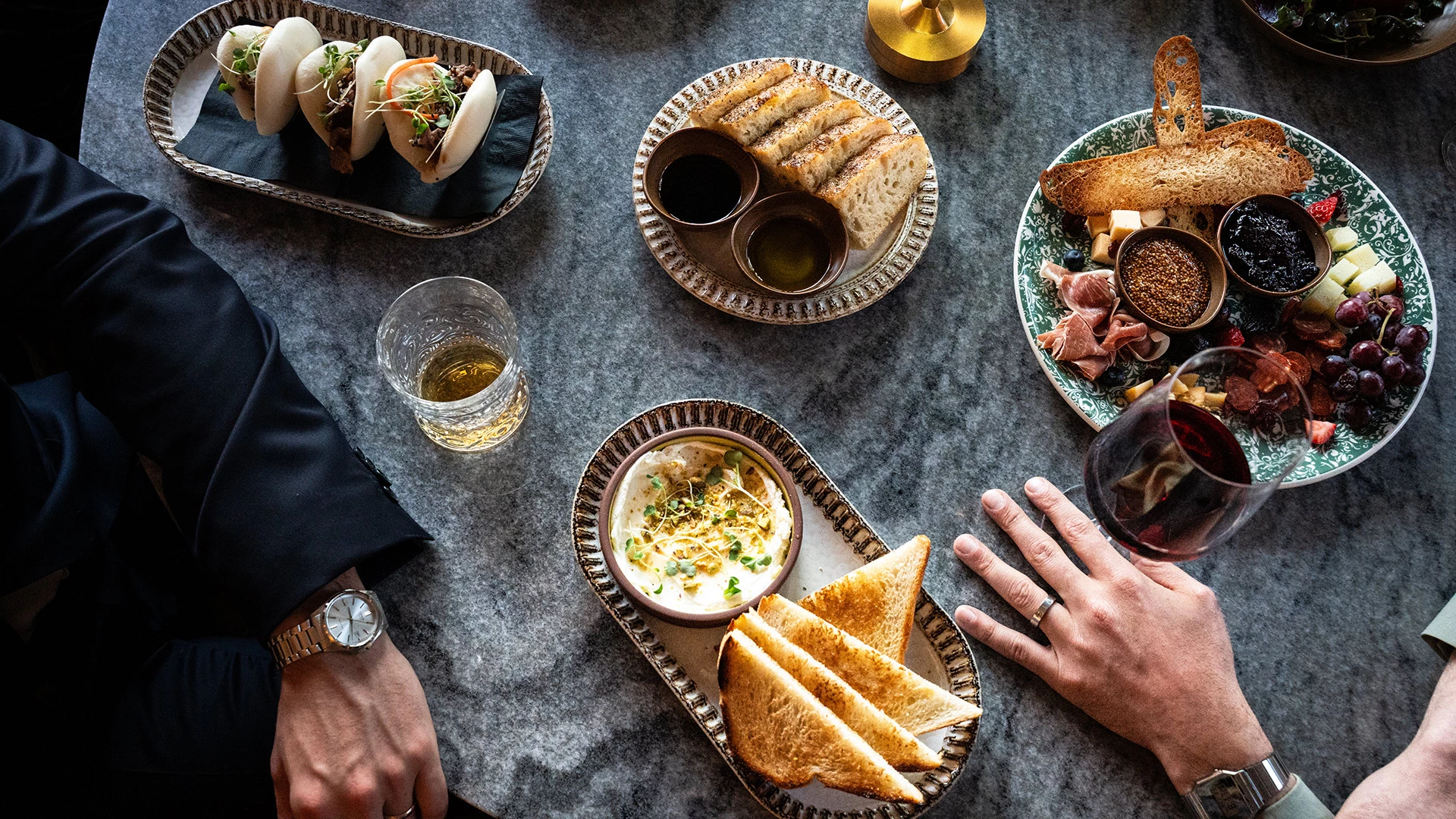 a table with plates of food and drinks