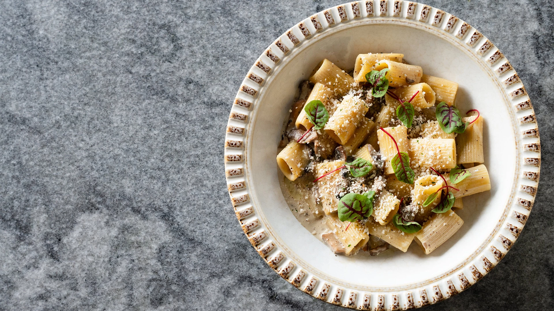 a plate of pasta with cheese and herbs