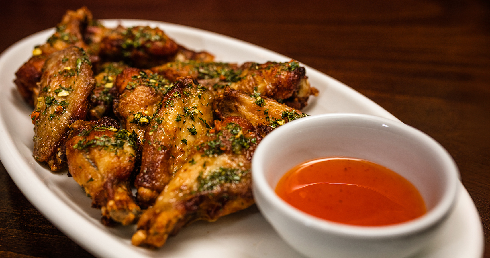 a plate of chicken wings and sauce