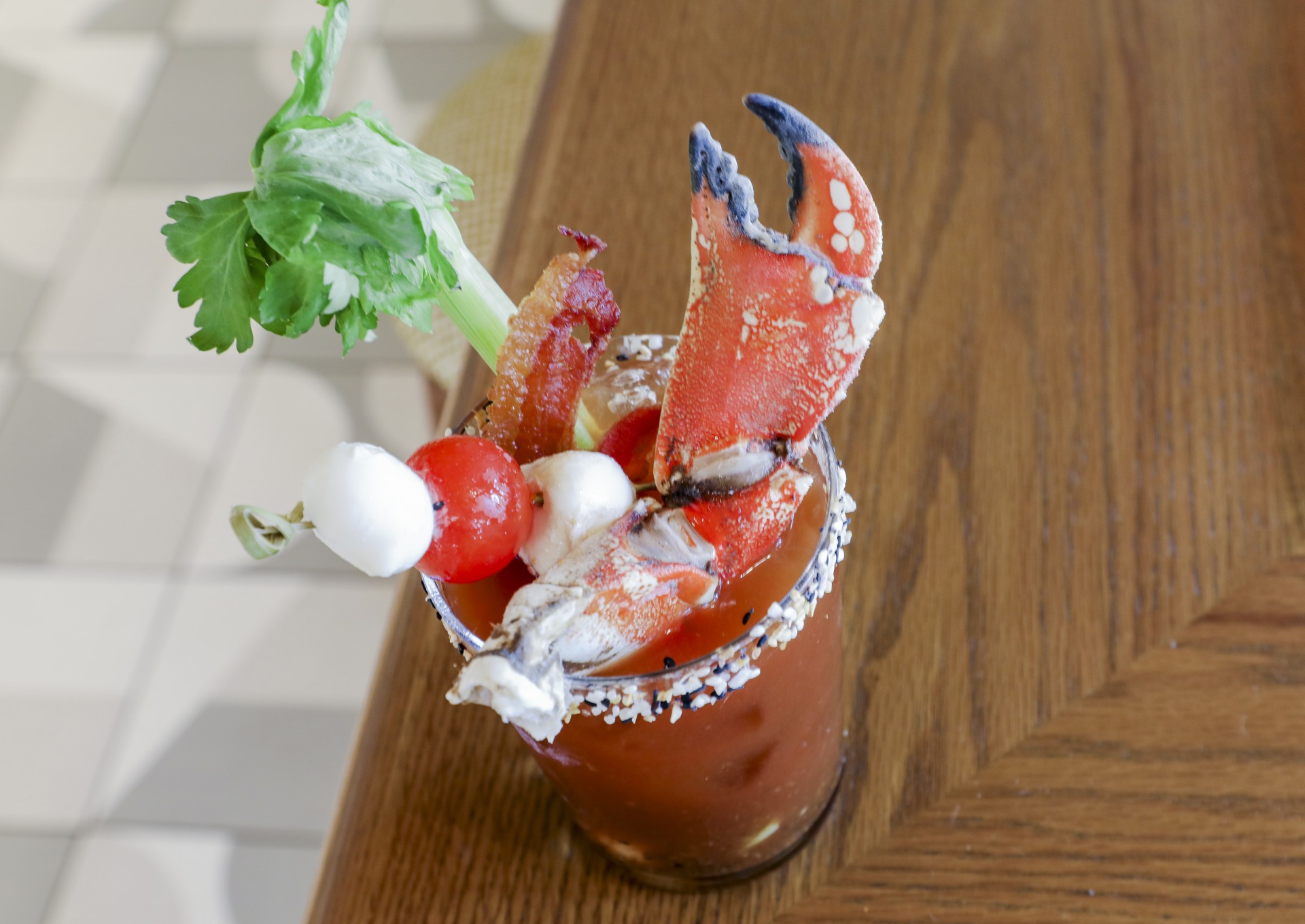 a bloody mary with crab claws and celery