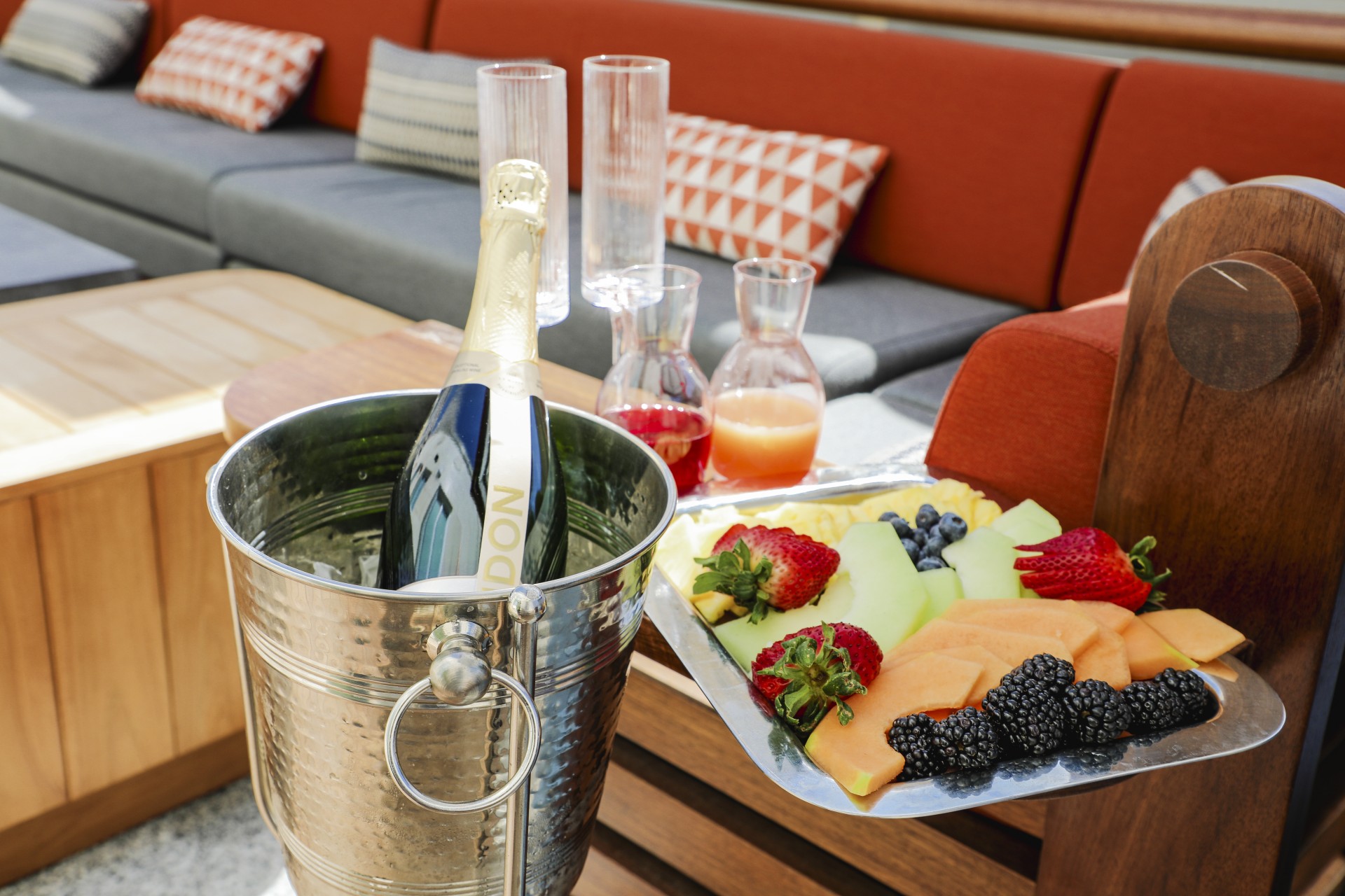 a champagne bottle and fruit in a bucket