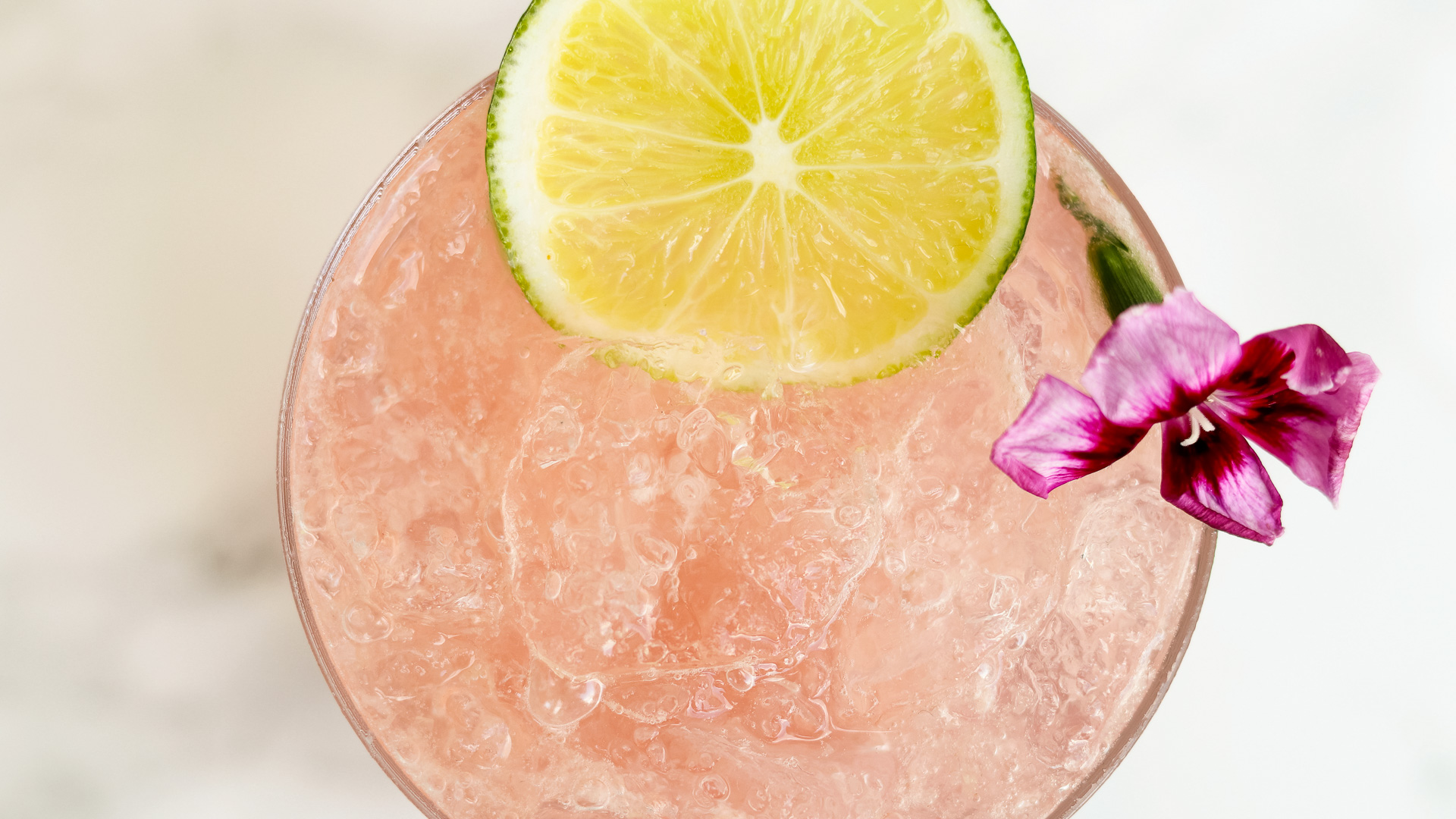 a glass with a drink and a slice of lime