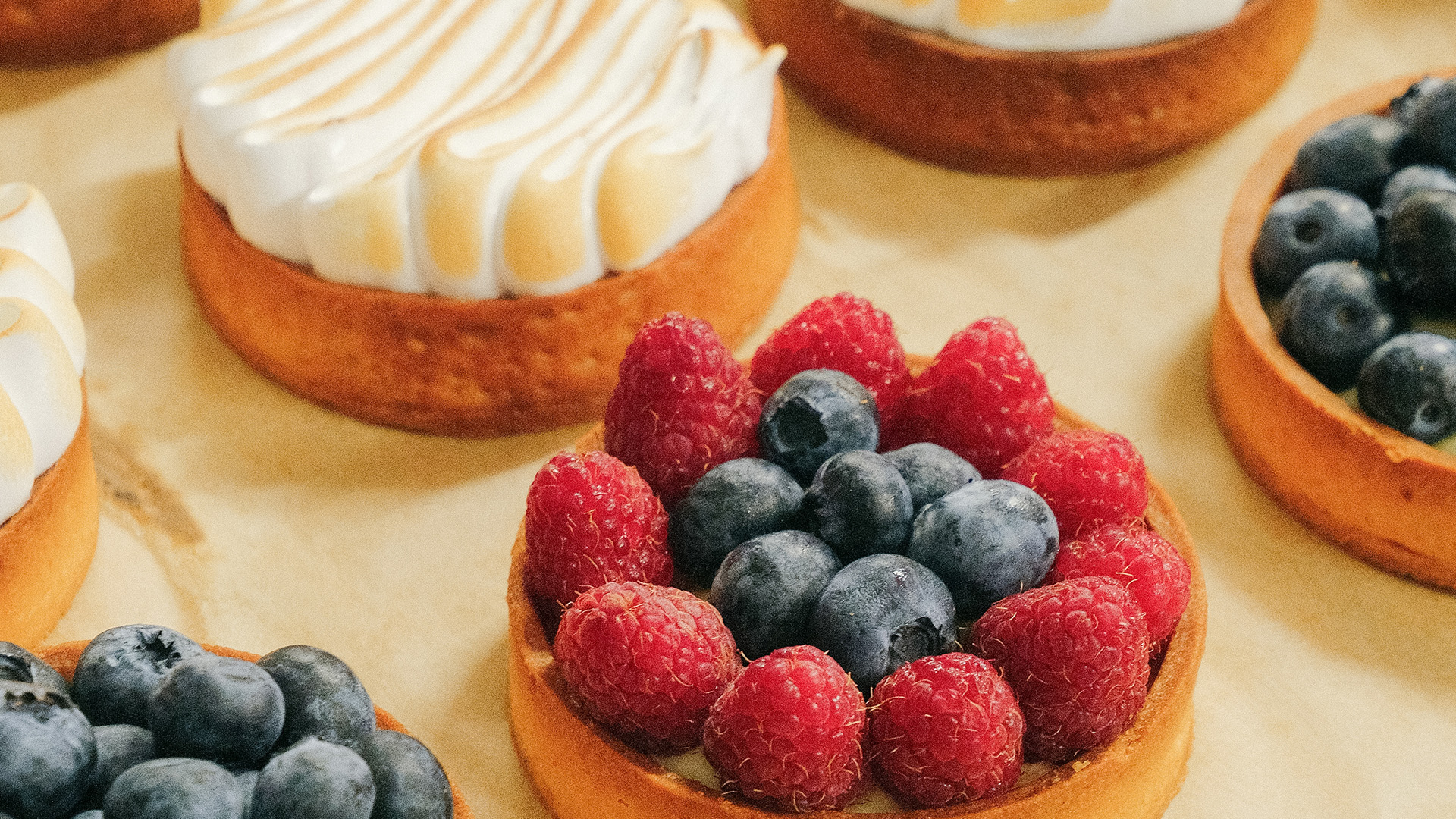 a group of desserts with berries