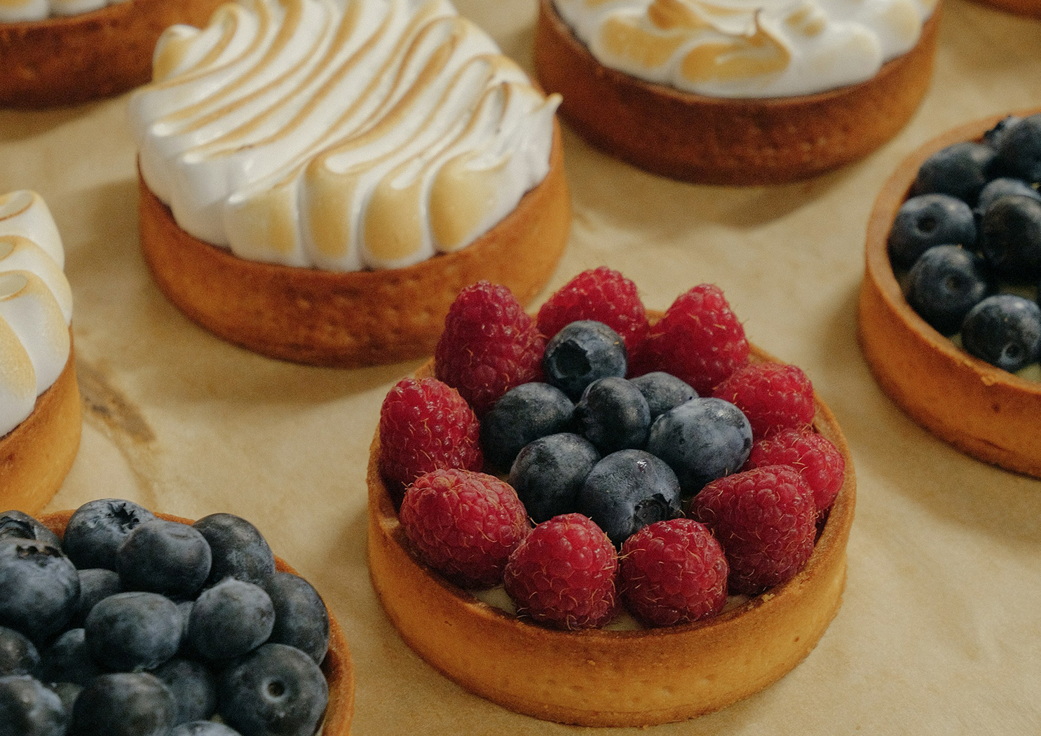 a group of desserts with berries