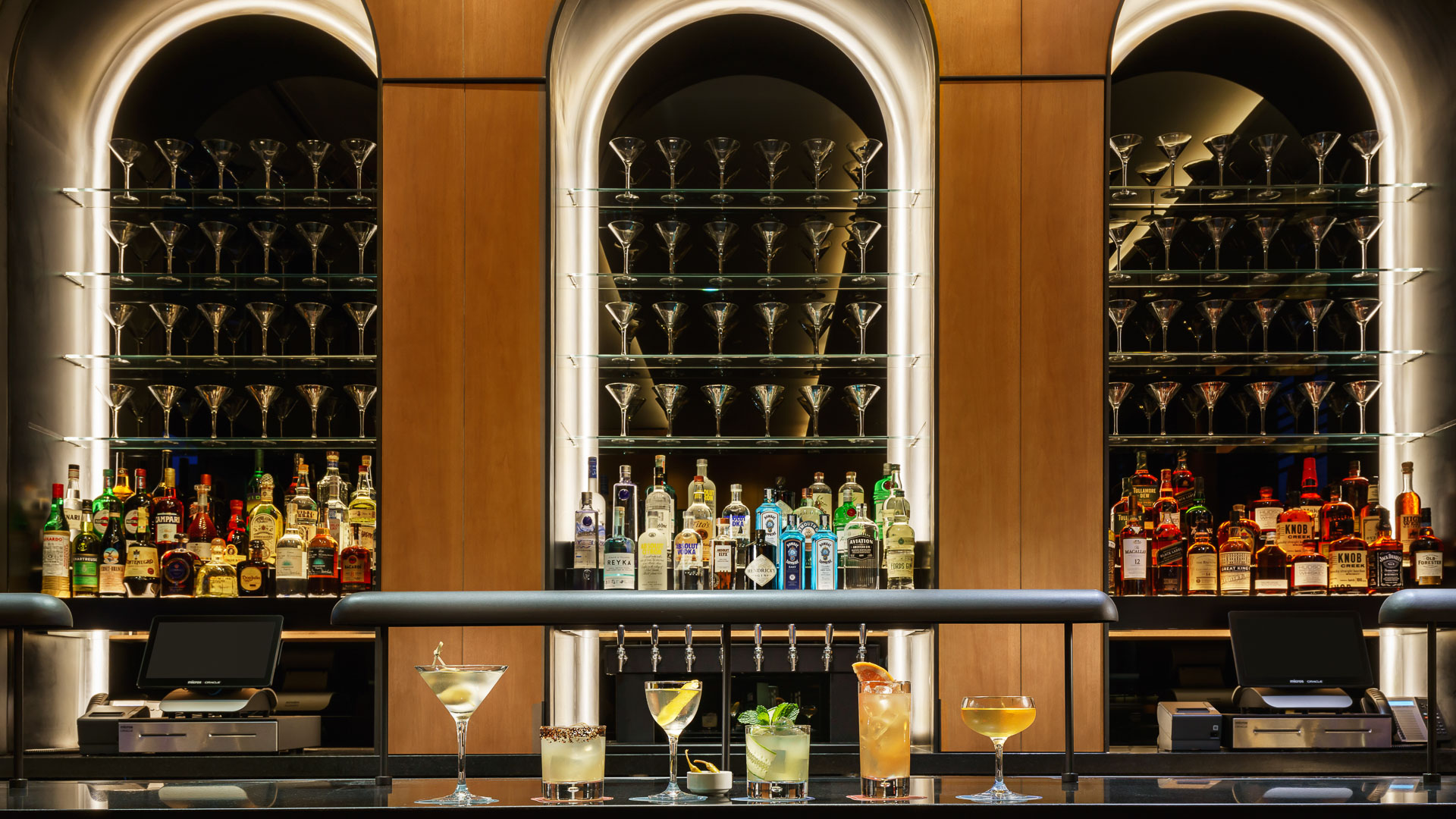 a bar with many glasses of alcohol