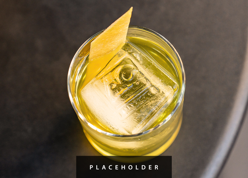 a glass with a drink and a slice of lemon