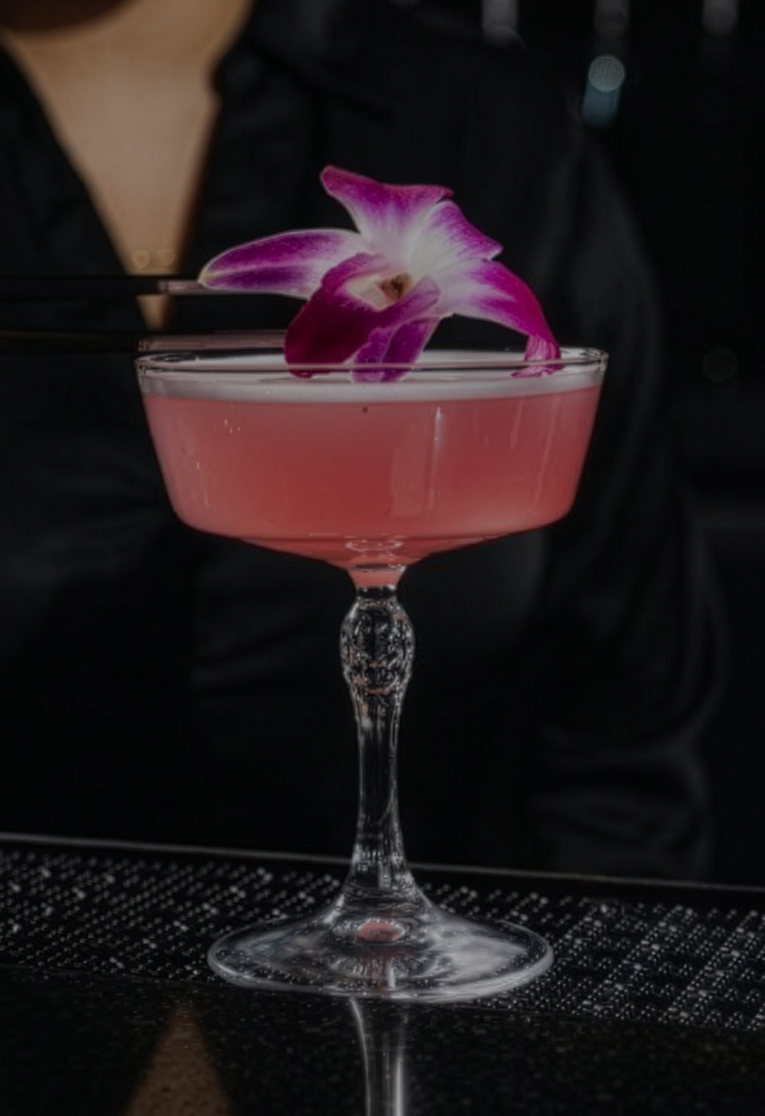 a pink drink with a flower on top of it