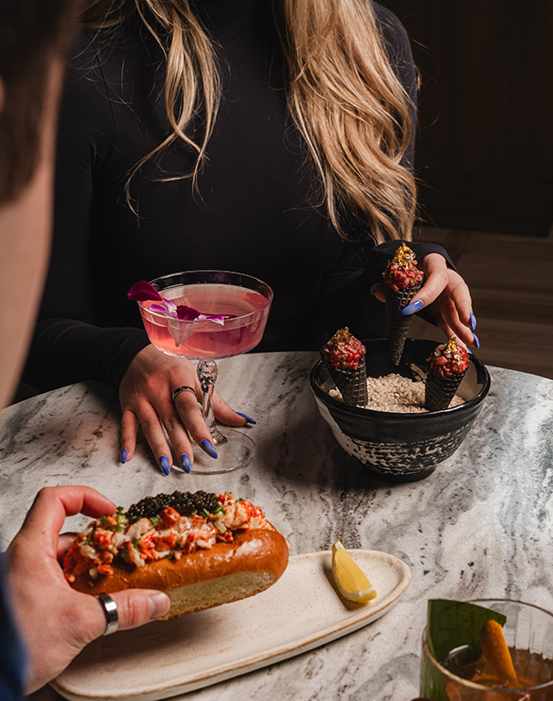 a woman holding a drink and a bowl of ice cream