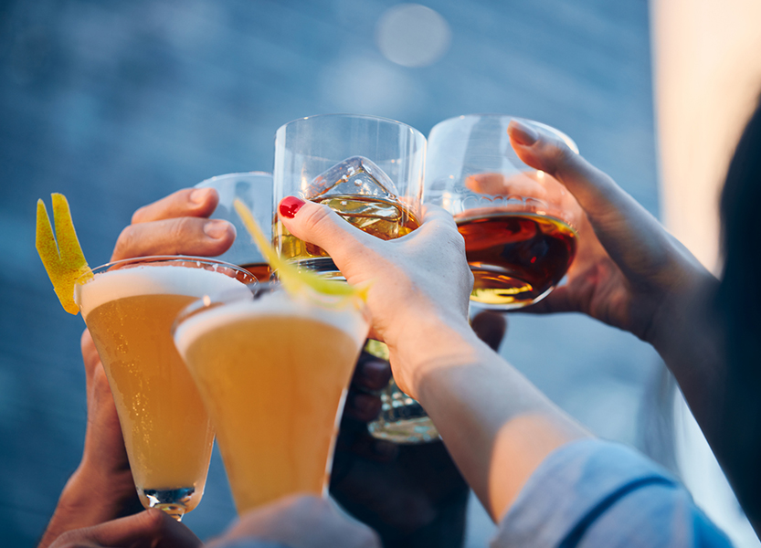 a group of people holding glasses of alcohol