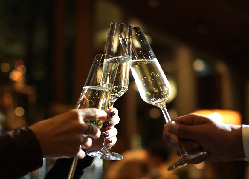 a group of people clinking champagne glasses