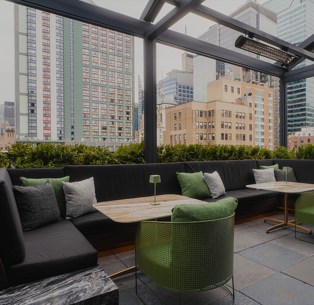 a patio with a table and chairs and a large window