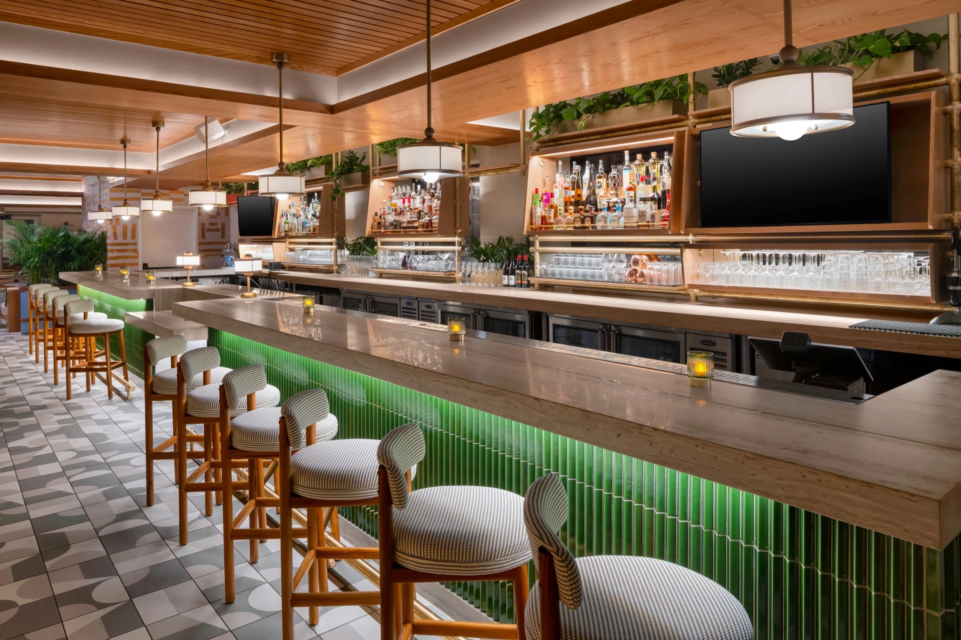 a bar with chairs and lights