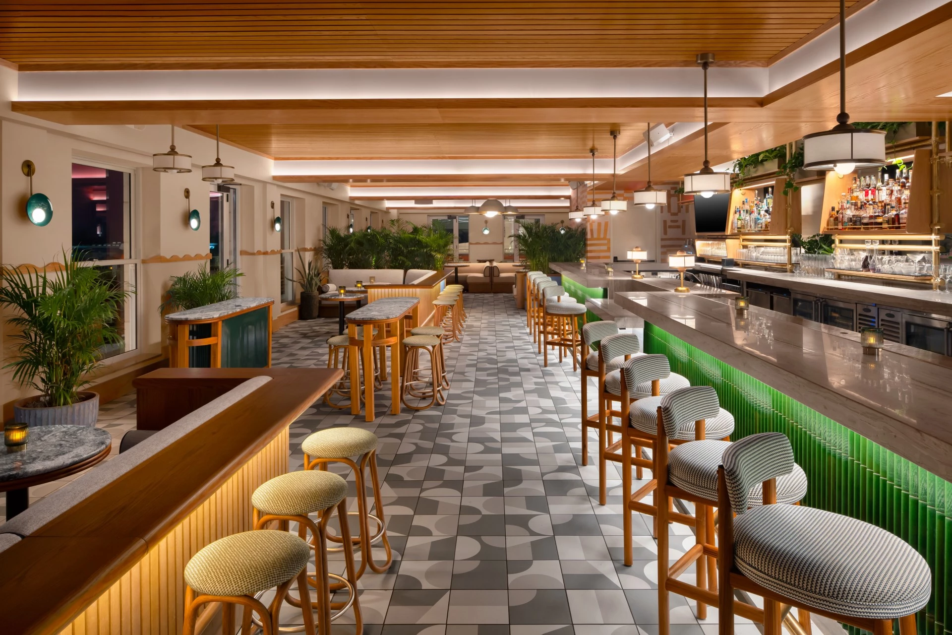 a bar with stools and tables