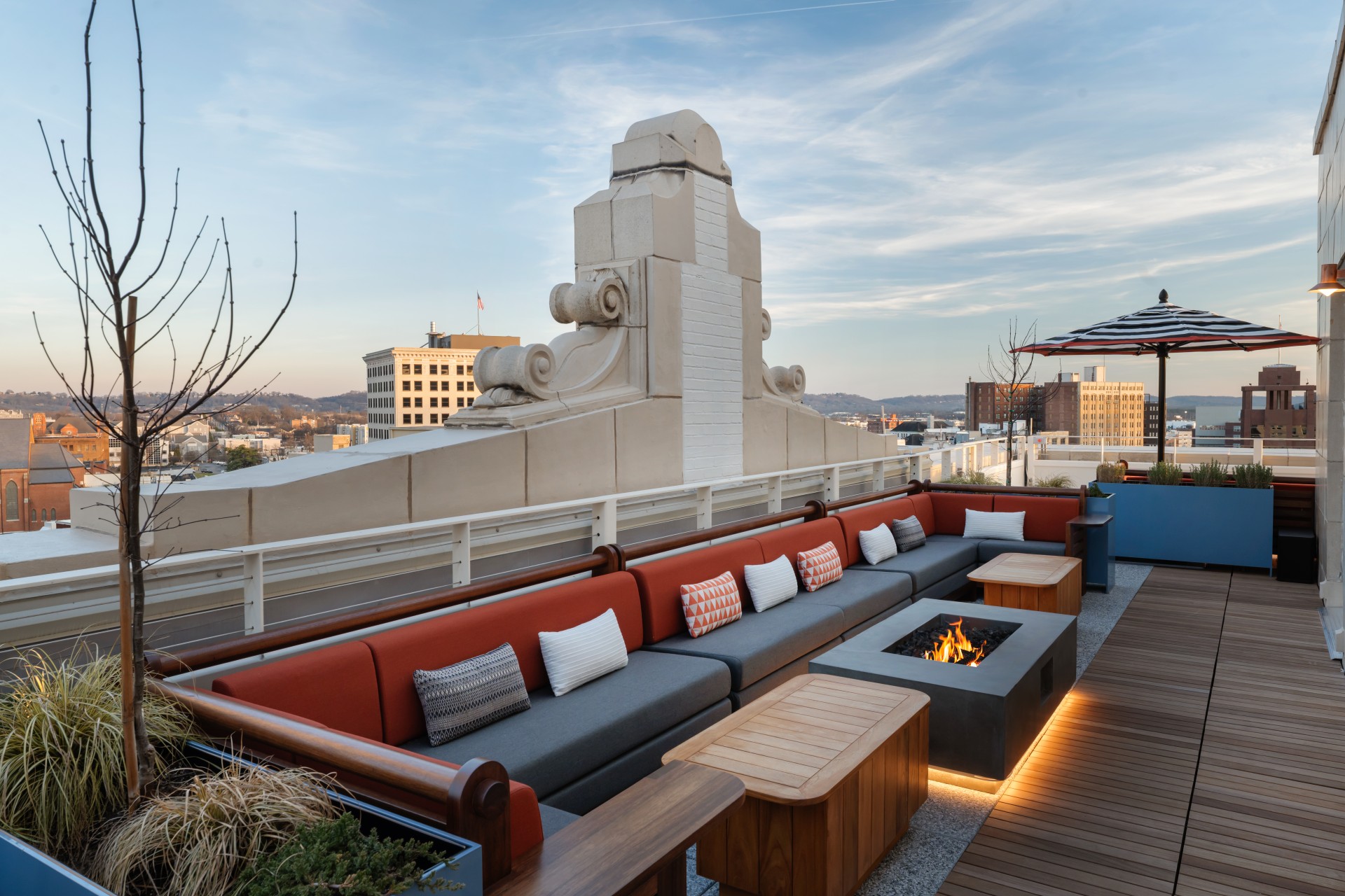 a patio with a fire pit and a bench