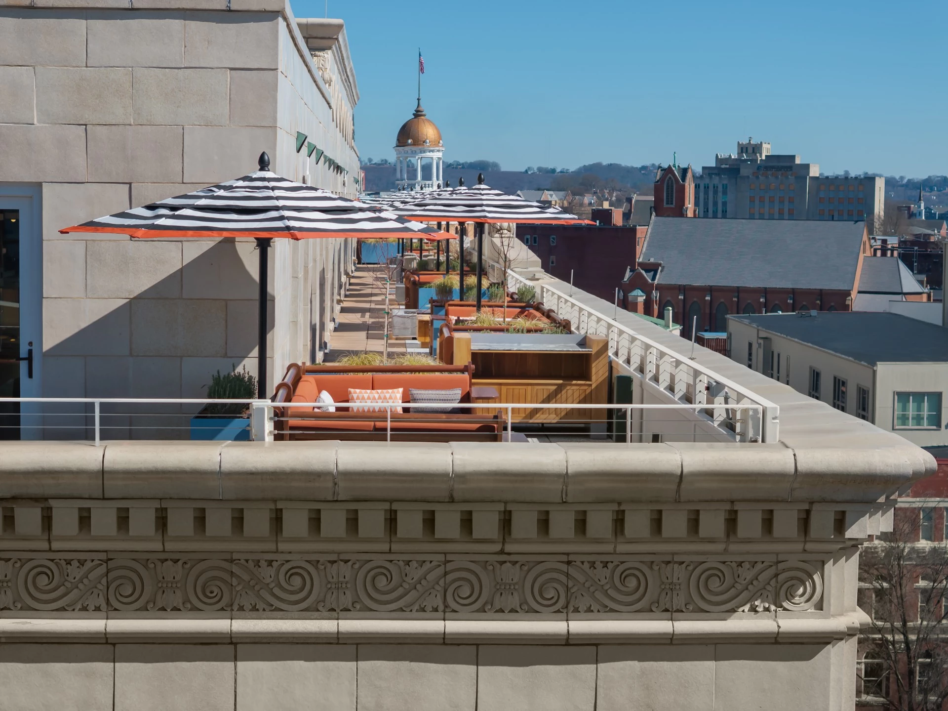 a rooftop patio with umbrellas and chairs
