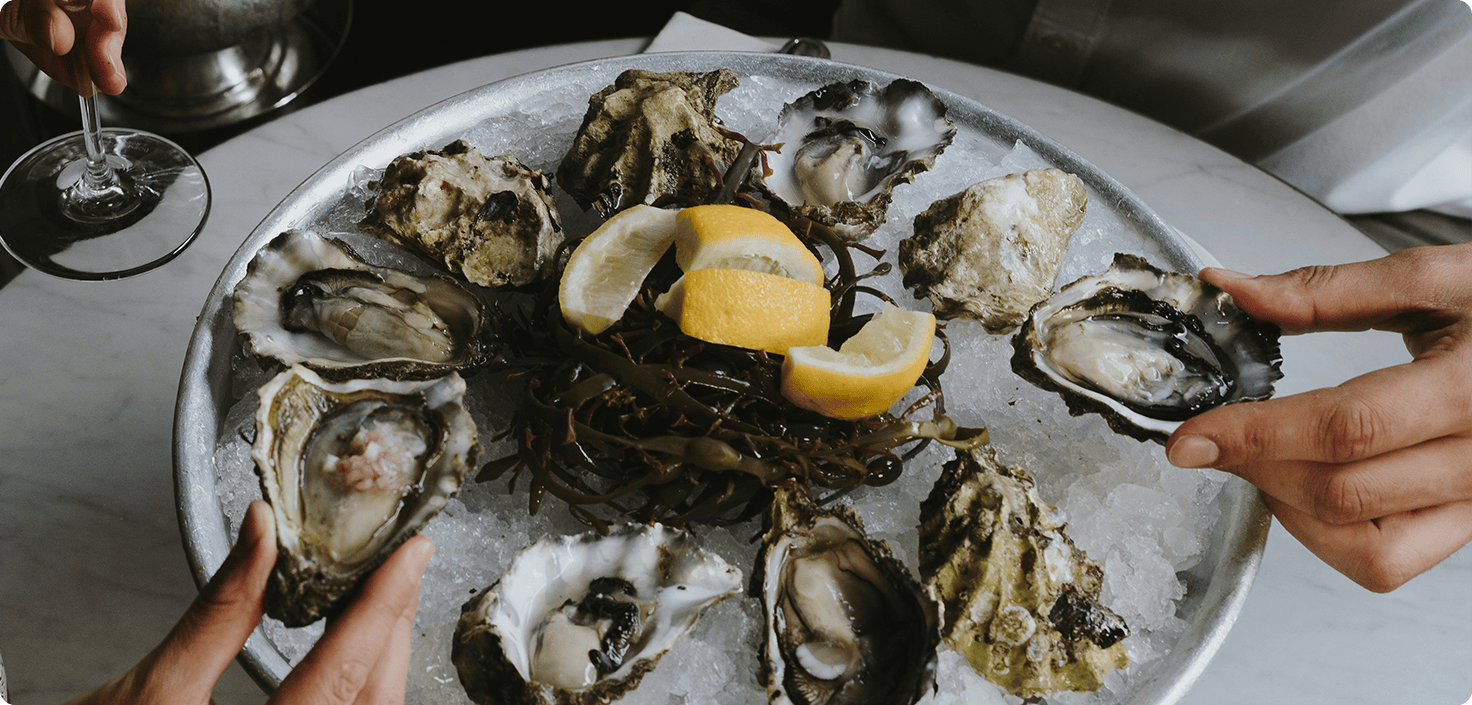 a plate of oysters and lemons