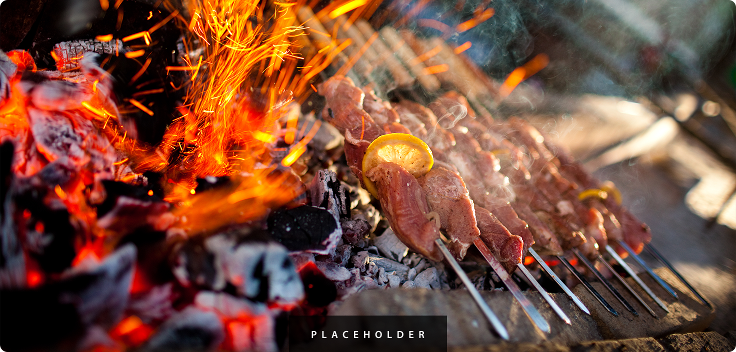 meat on skewers cooking over a fire