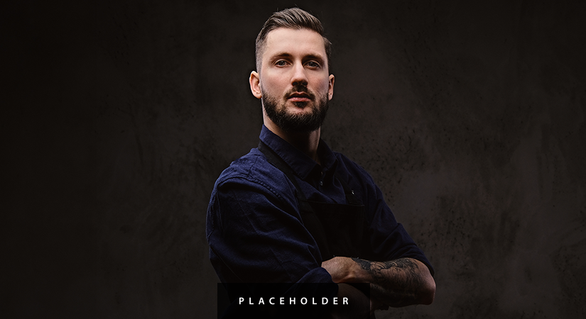 a man with a beard and a blue shirt