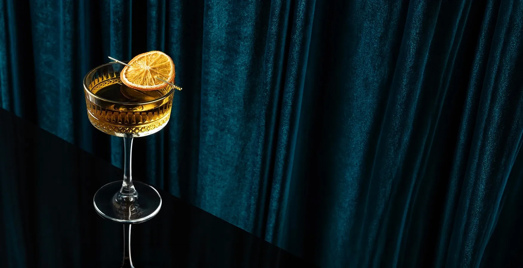 a glass with a drink and a slice of lemon