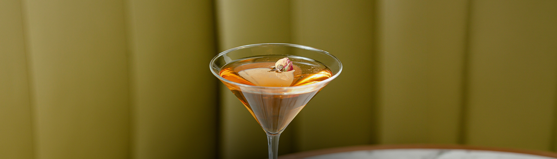 a glass with a rose in it