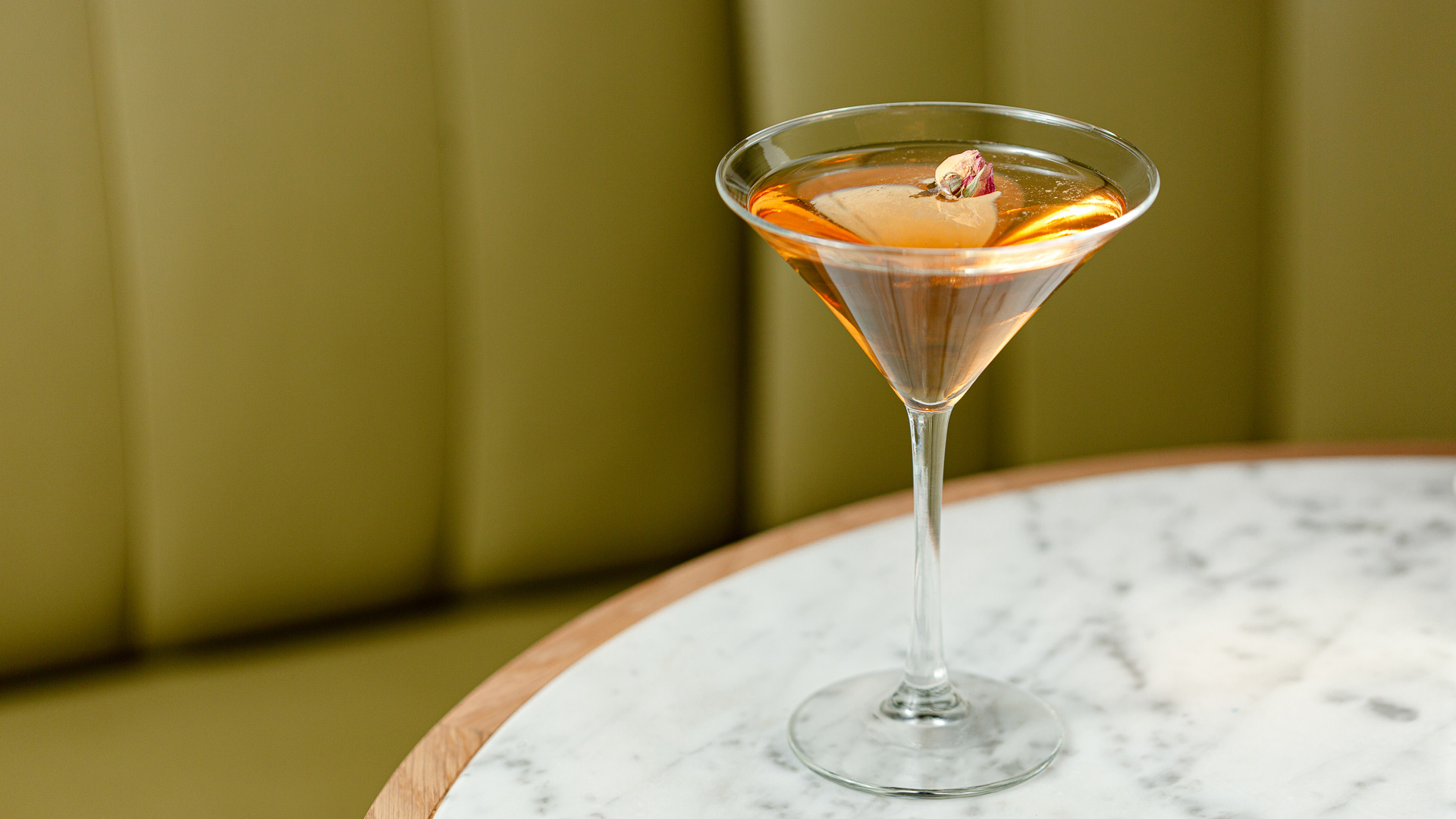 a glass with a drink on a table