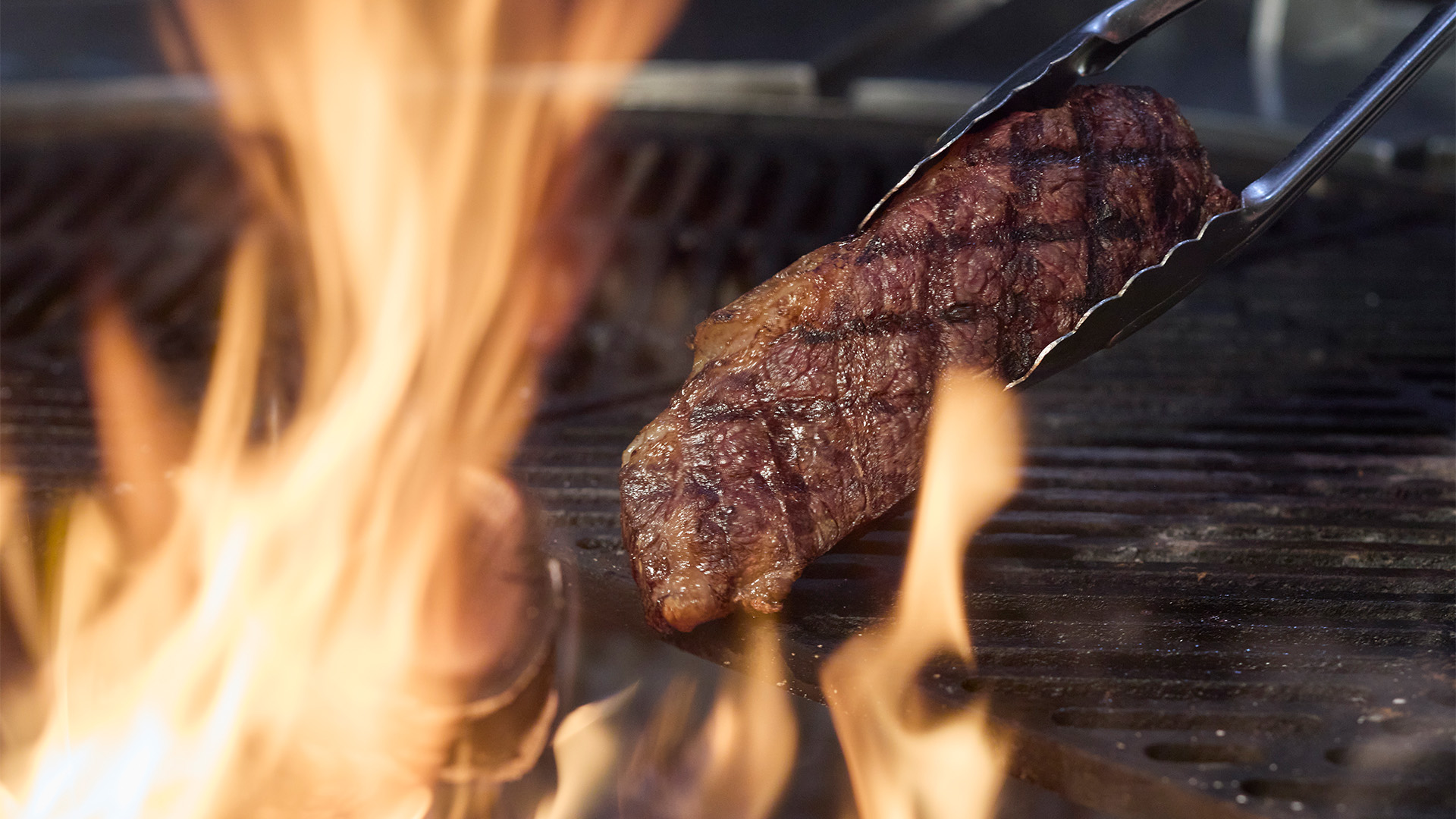 a steak being grilled on a grill