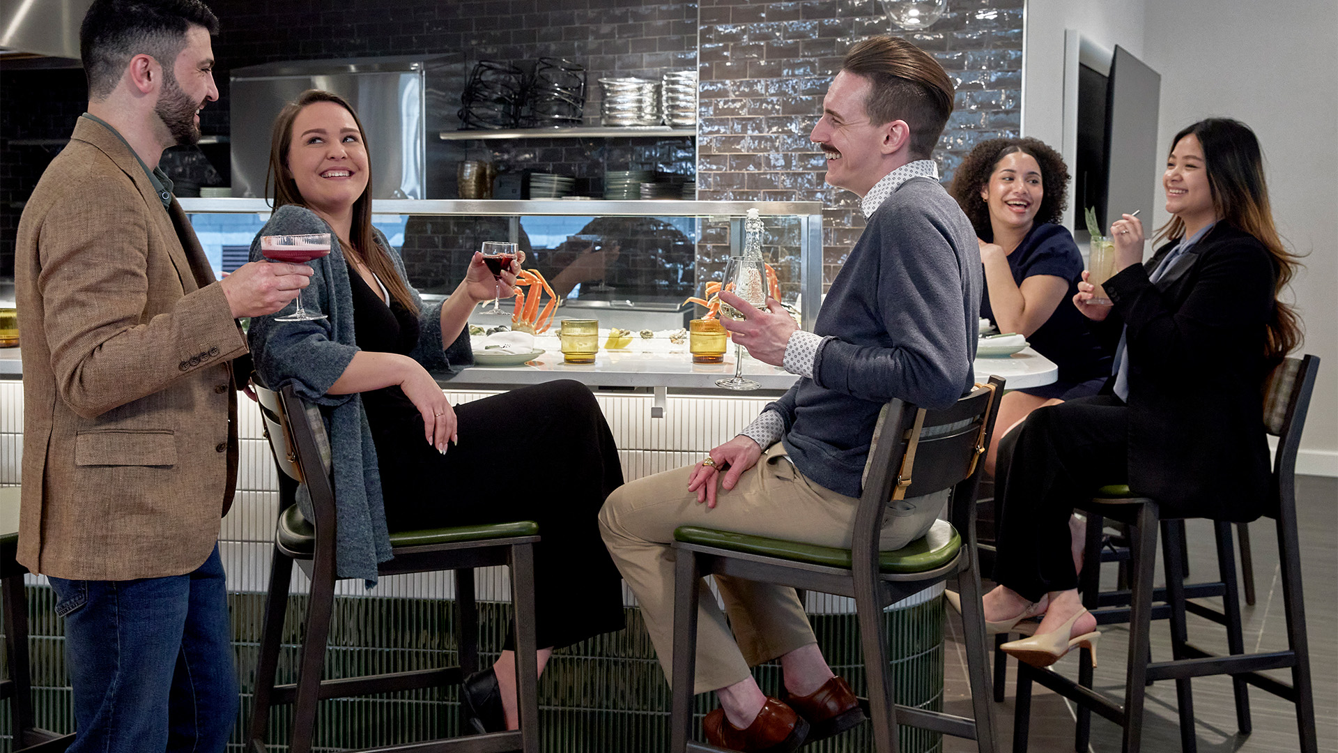 a group of people sitting at a bar