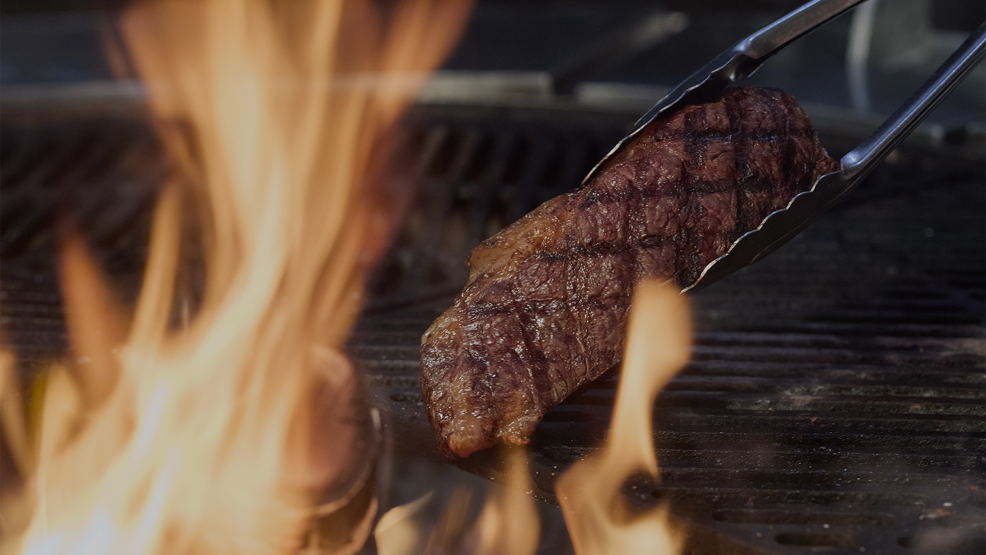a steak being grilled on a grill