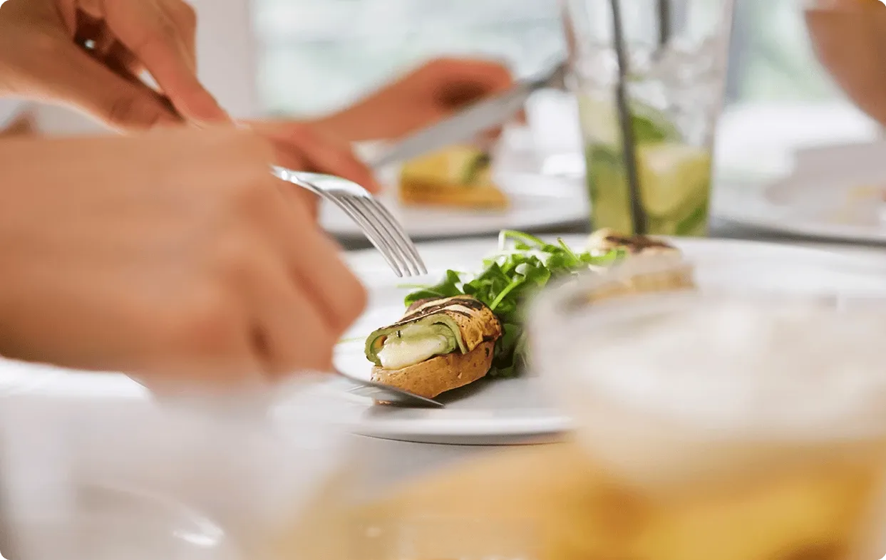 a person eating food on a plate