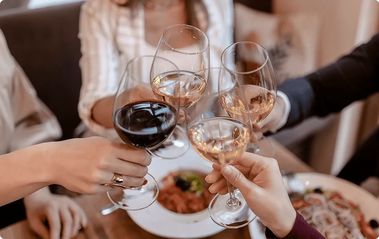 a group of people holding wine glasses