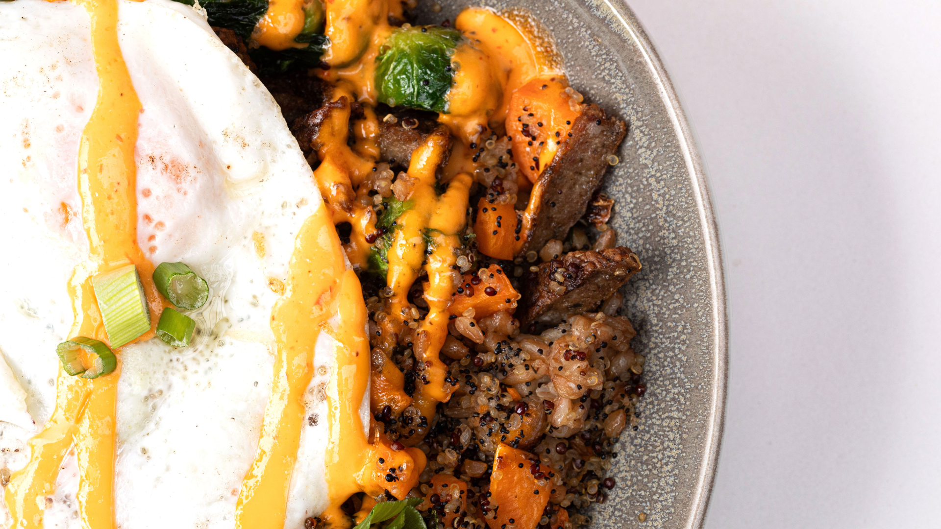 a plate of food with a fried egg and brisket