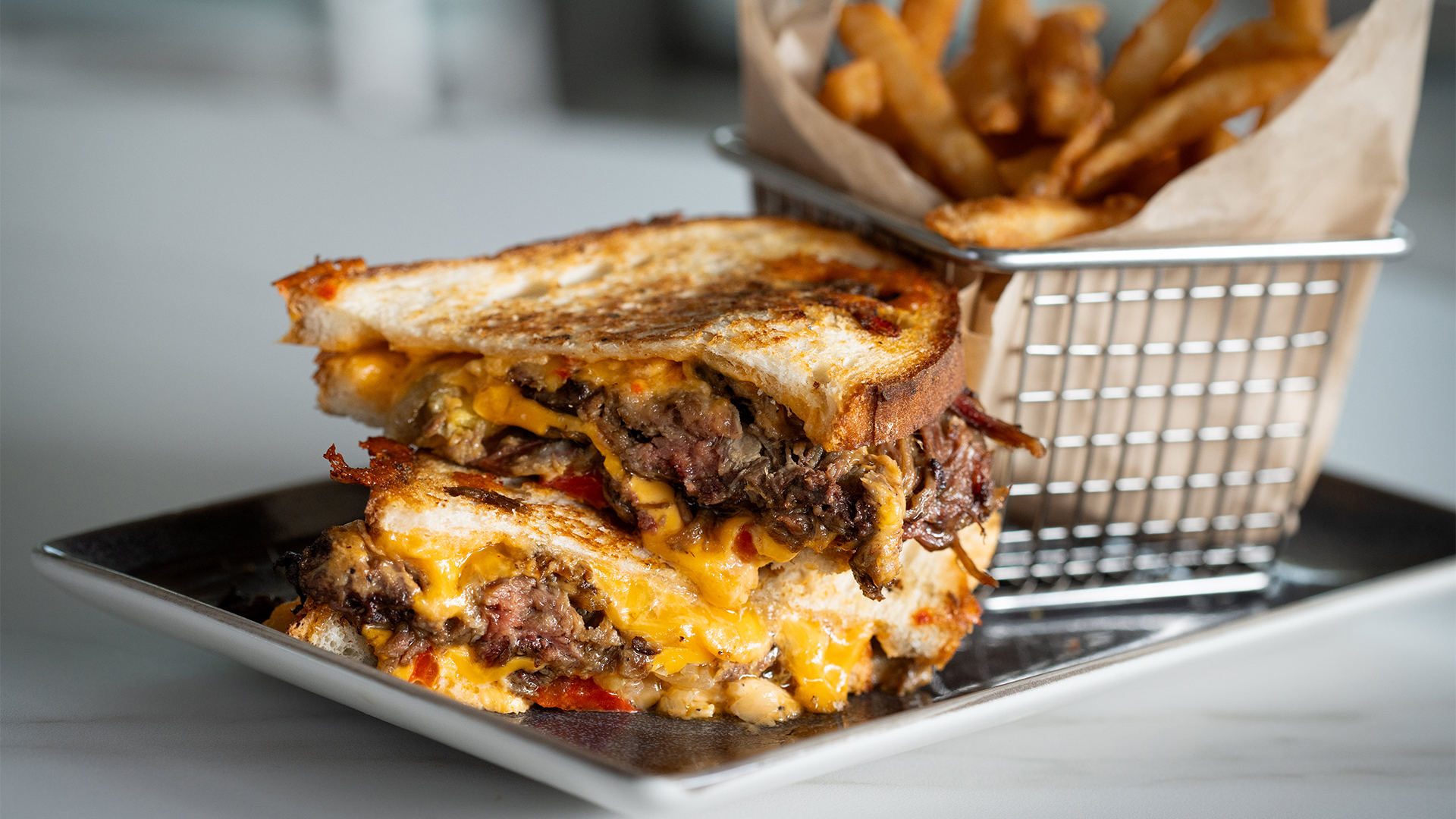 a grilled cheese sandwich with fries